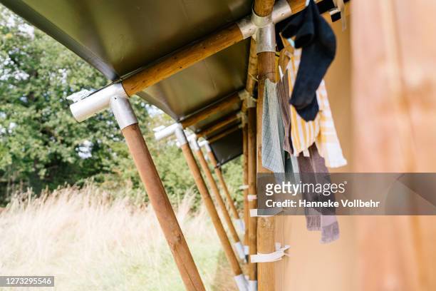 hanging laundry on a clothesline - kamperen stock-fotos und bilder