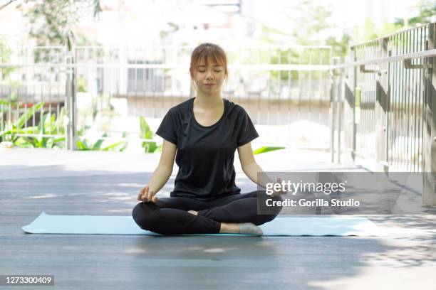 yong girl doing meditation in outdoors park to release stress and anxiety - chan yong park stock pictures, royalty-free photos & images