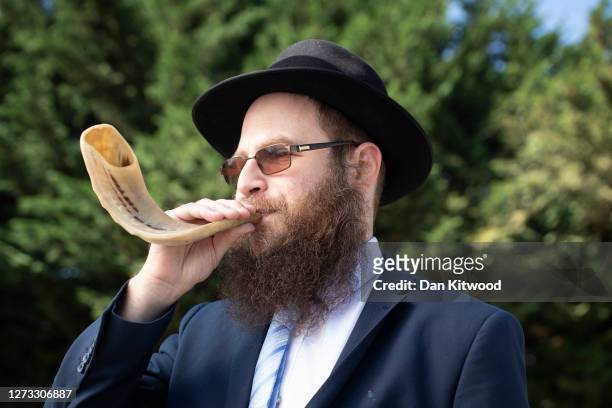 Rabbi Michael Wollenberg from the Woodford Forest United Synagogue demonstrates the blowing of a Shofar on September 18, 2020 in London, England. The...