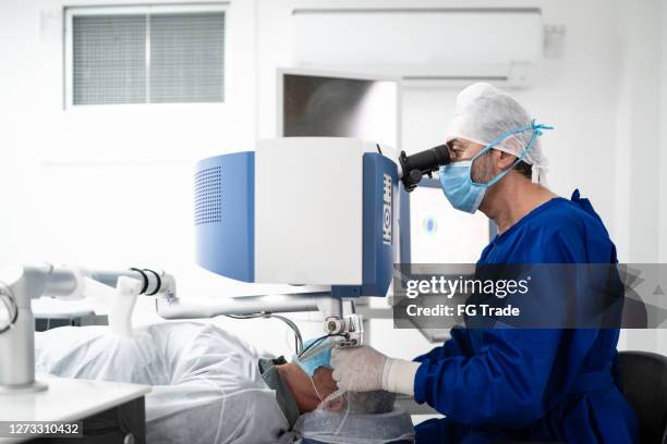 surgeon on an eye surgery - cataract eye stock pictures, royalty-free photos & images