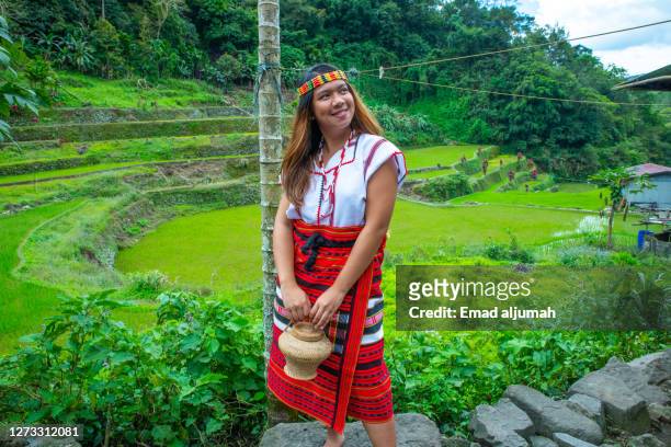 the woman is wearing the traditional clothing of ifugao in banue rice terraces (hagdan-hagdang palayan), philippines - ifugao province stock pictures, royalty-free photos & images
