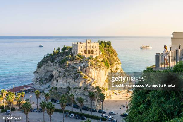 woman gazing at the sanctuary of santa marie dell'isola, tropea, italy. - calabria stock pictures, royalty-free photos & images