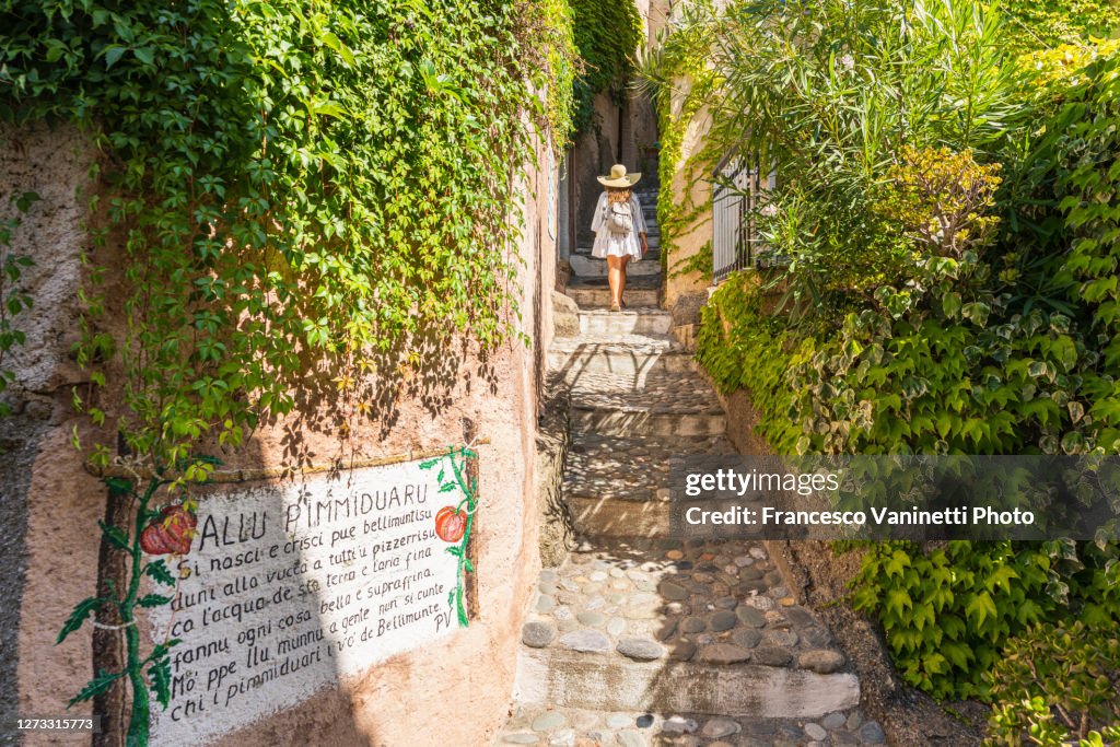 Woman visiting the village of Belmonte Calabro, Italy.