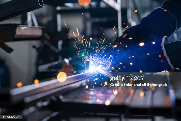 close up of an industrial worker welding steel with sparking - production line worker stock pictures, royalty-free photos & images