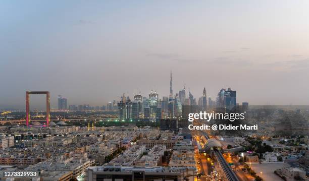 sunset over the dubai skyline  with burj khalifa, uae - dubai burj khalifa stock pictures, royalty-free photos & images