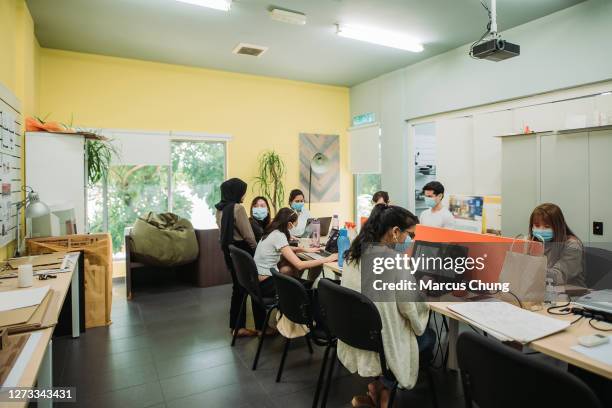 a group of asian students doing assignment in college classroom - malaysia architecture stock pictures, royalty-free photos & images