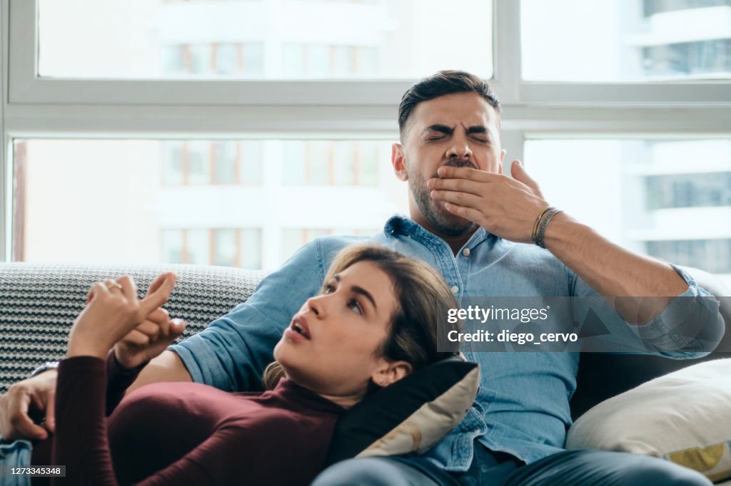 Man Yawning During Boring Conversation With Partner