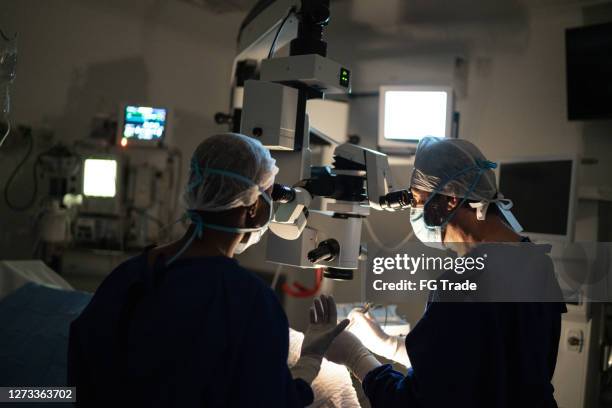 doctors doing an exam or surgery - micro surgery stock pictures, royalty-free photos & images