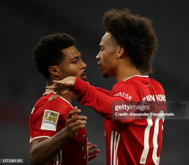 Serge Gnabry of Bayern Munich celebrates scoring his teams first goal of the game with team mates Leroy Sane during the Bundesliga match between FC...