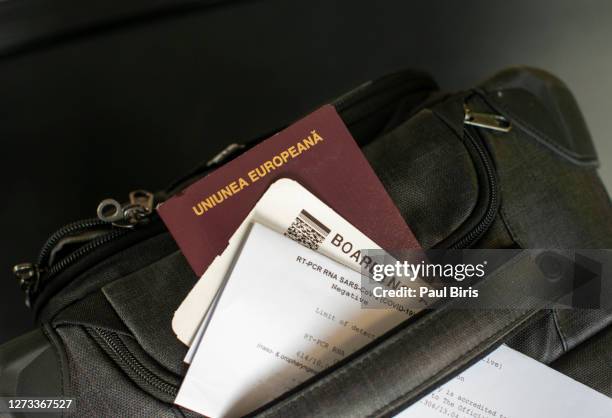 coronavirus airport restriction. a rt-pcr rna covid test with passport, plane ticket and suitcase at the airport - passagem de avião - fotografias e filmes do acervo