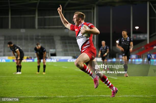 Dan Sargison of Salford Red Devils celebrates as he crosses the line to score a golden points try in extra time for victory over Catalans Dragons...