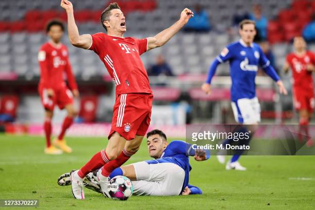Robert Lewandowski of FC Bayern Muenchen is foulded in the penalty area by Ozan Kabal of FC Schalke 04 during the Bundesliga match between FC Bayern...