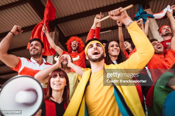 friends cheering at the stadium with megaphone - basketball fans stock pictures, royalty-free photos & images