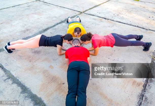 sports people practicing plank position - joint effort stock pictures, royalty-free photos & images