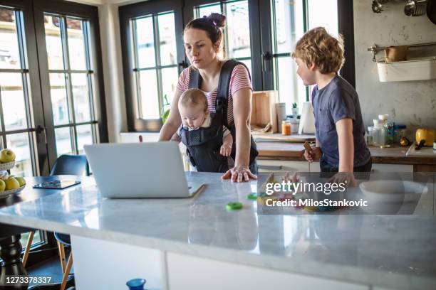 mother trying to work from home - leanincollection mother stock pictures, royalty-free photos & images
