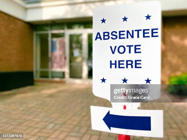 "absentee vote here" directional sign - absentee ballot stock pictures, royalty-free photos & images