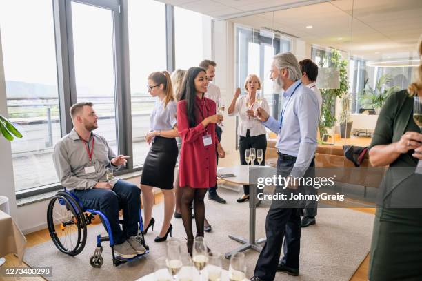 diverse business professionals socializing at office party - party board meets stock pictures, royalty-free photos & images