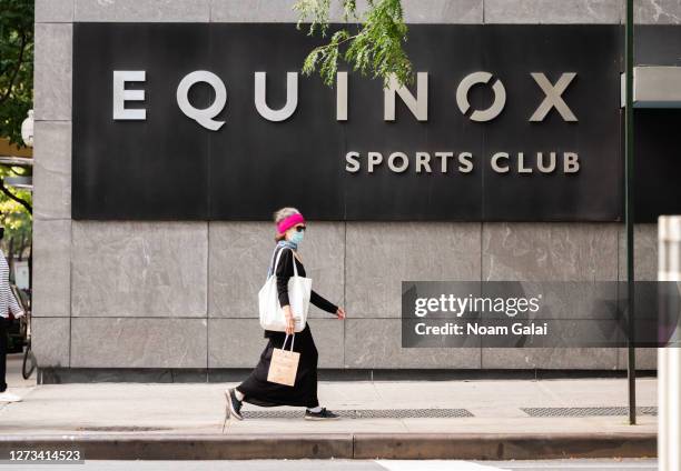 Person wears a protective face mask outside Equinox Sports Club on the Upper West Side as the city continues Phase 4 of re-opening following...