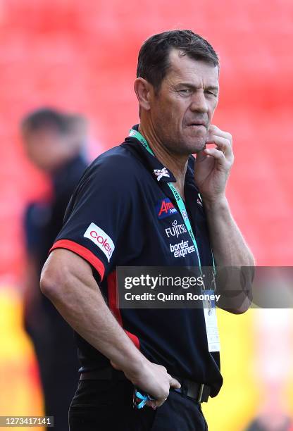 Bombers assistant coach Mark Harvey looks on during the round 18 AFL match between the Essendon Bombers and the Melbourne Demons at Metricon Stadium...