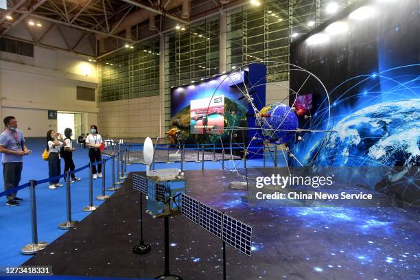 Visitors look at a model of China's BeiDou Navigation Satellite System during 2020 China Space Conference on September 18, 2020 in Fuzhou, Fujian...