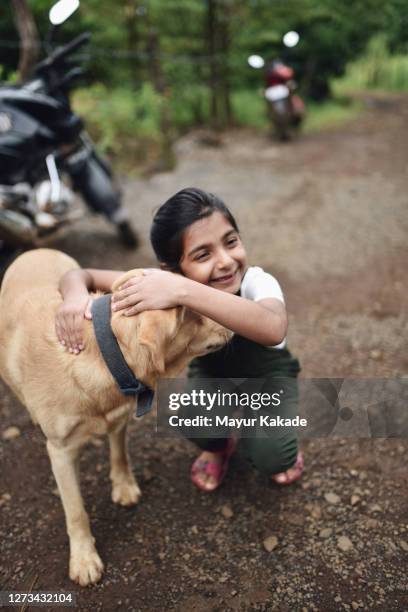 girl hugs her pet labrador retriever dog - emotional support animal stock pictures, royalty-free photos & images