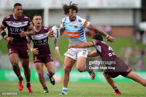 Kevin Proctor of the Titans makes a break during the round 19 NRL match between the Manly Sea Eagles and the Gold Coast Titans at Lottoland on...