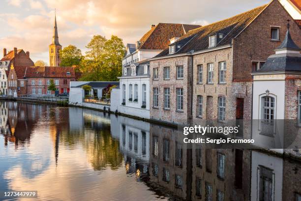 idyllic canal in bruges, belgium - belgium canal stockfoto's en -beelden