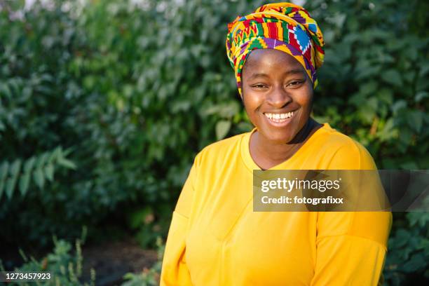 summer outdoor portrait: cheerful laughing african woman looking into camera - head tie stock pictures, royalty-free photos & images
