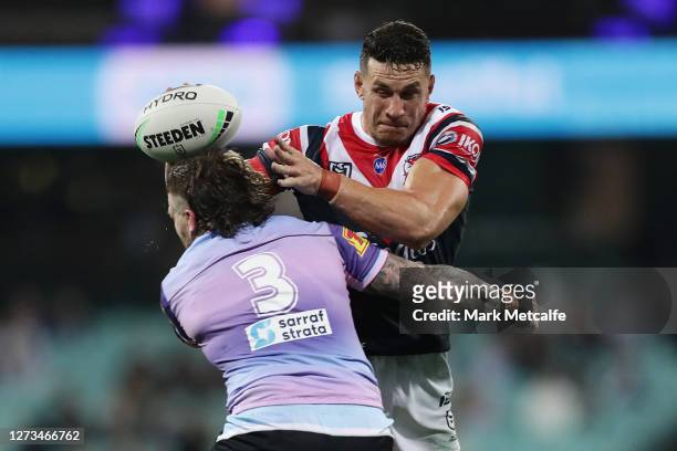 Sonny Bill Williams of the Roosters is tackled during the round 19 NRL match between the Sydney Roosters and the Cronulla Sharks at Sydney Cricket...