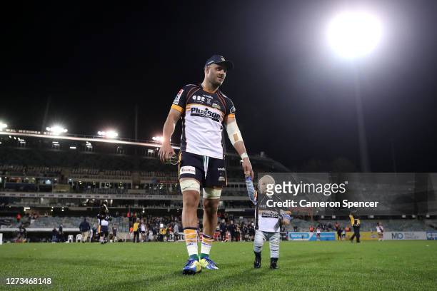 Lachlan McCaffrey of the Brumbies and his child celerbate winning the Super Rugby AU Grand Final between the Brumbies and the Reds at GIO Stadium on...