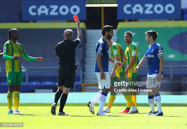 Kieran Gibbs of West Bromwich Albion is shown the red card by Match Referee Mike Dean during the Premier League match between Everton and West...