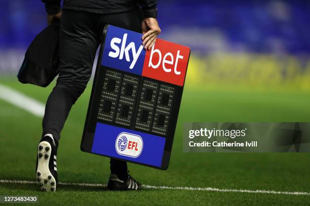 The fourth official carrys the Sky Bet EFL substitutes board across the pitch ahead of the Sky Bet Championship match between Coventry City and...