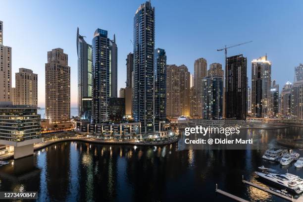 twilight over the luxury dubai marina - dubai water canal stock pictures, royalty-free photos & images