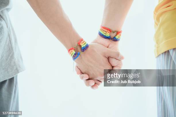 multiracial gay couple holding hands - bracelet fotografías e imágenes de stock