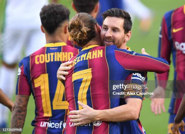 Antoine Griezmann of FC Barcelona celebrates with teammate Lionel Messi after scoring his team's first goal during the Joan Gamper Trophy match...