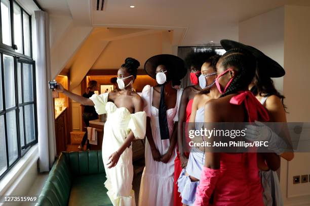 Models wearing PPE face masks take a selfie during the Maison Bent appointments during LFW September 2020 at on September 19, 2020 in London, England.