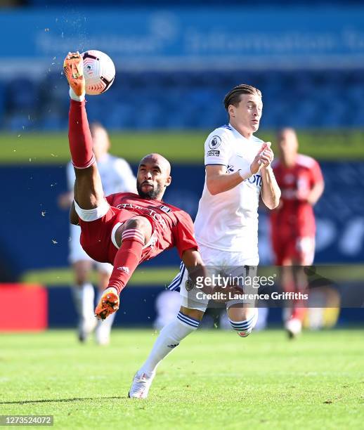 Denis Odoi of Fulham makes an overhead kick under pressure from Ezgjan Alioski of Leeds United during the Premier League match between Leeds United...