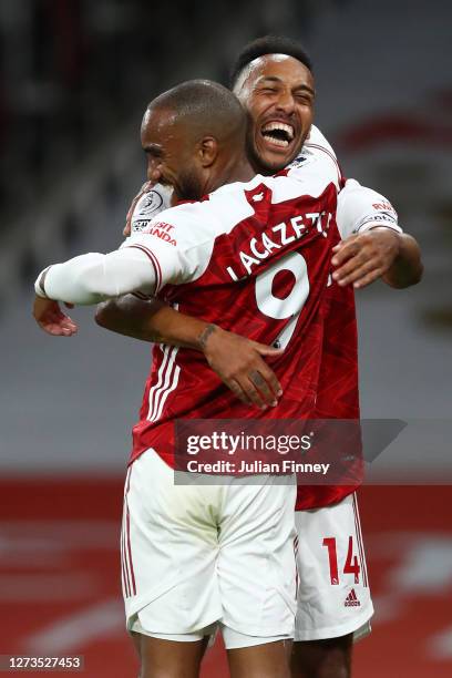 Alexandre Lacazette of Arsenal celebrates with teammate Pierre-Emerick Aubameyang after scoring his team's first goal during the Premier League match...