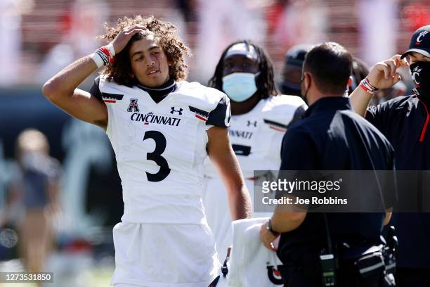 Evan Prater of the Cincinnati Bearcats reacts after being cut under the eye while running with the ball in the fourth quarter of the game against the...