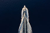 Aerial view on fast boat on blue Mediterranean sea at sunny day. Fast ship on the sea surface. Seascape from the drone. Seascape from air. Travel - image