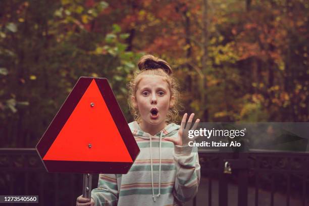 girl holding a red triangle sign - auburn v kentucky stock pictures, royalty-free photos & images