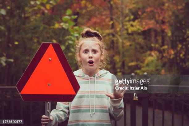 girl holding a red triangle sign - auburn v kentucky stock pictures, royalty-free photos & images