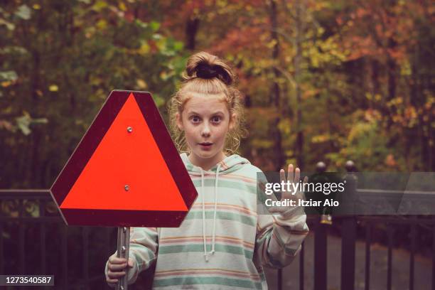 girl holding a red triangle sign - auburn v kentucky stock pictures, royalty-free photos & images