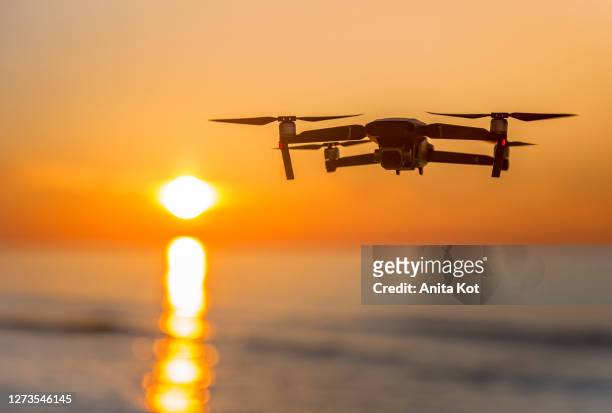 drone flying over the sea - toy helicopter stock pictures, royalty-free photos & images