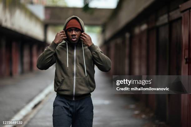 warm blijven na zijn run - man and his hoodie stockfoto's en -beelden