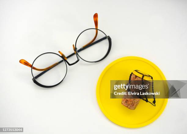 yellow coaster, champagne cork and reading glasses - occhiali da lettura foto e immagini stock