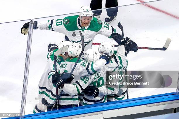 Joel Hanley of the Dallas Stars is congratulated by his teammates after scoring a goal against the Tampa Bay Lightning during the first period in...