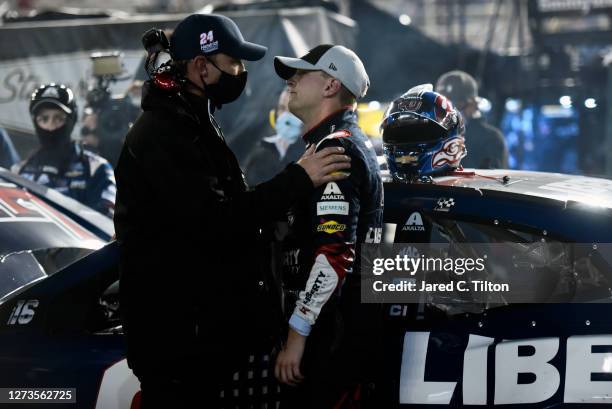 William Byron, driver of the Liberty University Chevrolet, is embraced by crew crew chief Chad Knaus in the garage after an on-track incident during...