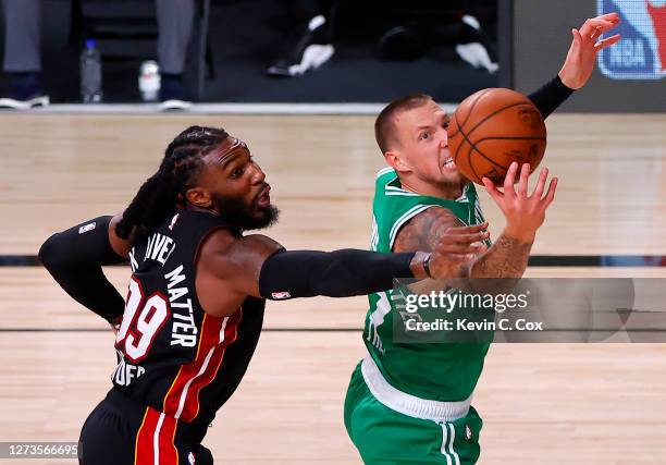 Jae Crowder of the Miami Heat and Daniel Theis of the Boston Celtics battle for a rebound during the third quarter in Game Three of the Eastern...