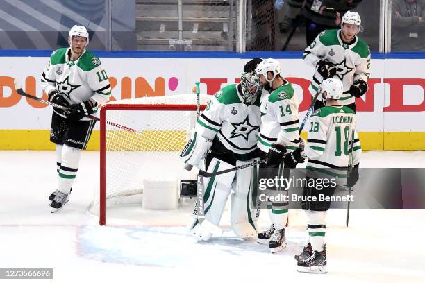 Anton Khudobin and Jamie Benn of the Dallas Stars celebrate their teams 4-1 victory against the Tampa Bay Lightning in Game One of the 2020 NHL...